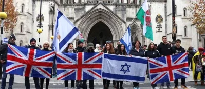 Demonstrators display Israeli and British flags during a march against anti-Semitism.  Photo: Reuters